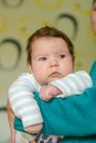 The guy in his arms looks down. A mother holds her newborn baby in her arms, looking at him with a happy look. The boy feels Royalty Free Stock Photo