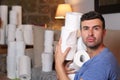 Guy hoarding toilet paper rolls