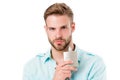 Guy hold perfume bottle. Bearded man with deodorant isolated on white background. Fashion cologne bottle. Hygiene and