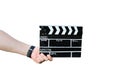 Guy is holding black clapperboard in hands. Man is directing and filming some amateur cinema movie. Isolated on white background