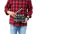 Guy is holding black clapperboard in hands. Man is directing and filming some amateur cinema movie. Isolated on white background