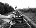 Guy is holding black clapperboard in hands. Man is directing and filming some amateur cinema movie. Rail trails on the background