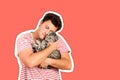 A guy holding a British cat in his arms and hugging her. emotional man isolated Magazine collage style with trendy color