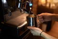 Guy holding metal cup and testing coffee machine Royalty Free Stock Photo