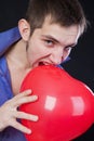 guy holding a red heart-shaped balloon Royalty Free Stock Photo