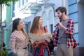 Guy holding sunglasses girl with map another mulatto standing on street Royalty Free Stock Photo