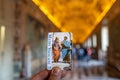 A guy holding a ticket to the Museum of Vatican inside the museum. Beautiful bokeh, focuse is on the ticket Musei Vaticani Royalty Free Stock Photo