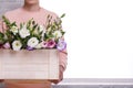 The guy in holds a box with Japanese roses. Front view against white window background Royalty Free Stock Photo