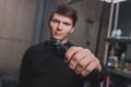 A guy holds an electric shaving machine. Hairdressing