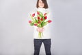 Guy holds flowers. Tulips in the hands of a young man. Flower congratulations for women.Male hands with bouquet of spring flowers Royalty Free Stock Photo