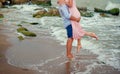 The guy holds the girl in his arms on the beach Royalty Free Stock Photo