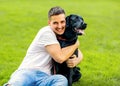 Guy hugging with his dog labrador playing in the park