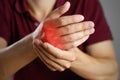 The guy hurts his hand. The pain in his fist. Closeup. The lesion is highlighted in red