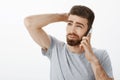 Guy intense, awkward trying say no during phone call. Unsure hesitating handsome boyfriend with beard and sick eyebrows