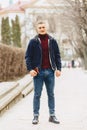 Guy in jacket stands in middle of alley Royalty Free Stock Photo