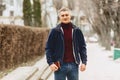 Guy in jacket stands in middle of alley Royalty Free Stock Photo