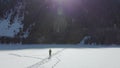 Guy jogging on a frozen mountain lake