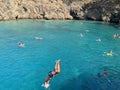 The guy jumps from the deck of the ship into the sea. A man dives into the water from a height. Swimming in the Mediterranean Sea