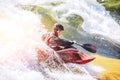 Guy in kayak sails mountain river. Whitewater kayaking, extreme sport rafting Royalty Free Stock Photo