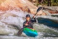 Guy in kayak sails mountain river. Whitewater kayaking, extreme sport rafting Royalty Free Stock Photo