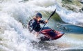 Guy in kayak sails mountain river. Whitewater kayaking, extreme sport rafting