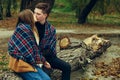 Guy kisses girl wrapped in plaid