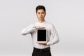 Guy knows exactly what you need. Serious-looking sassy and elegant asian man in formal outfit, holding digital tablet Royalty Free Stock Photo