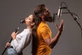 Guy and lady with excited faces enjoy music. Karaoke singer couple. Man and woman singing with music microphone. Royalty Free Stock Photo