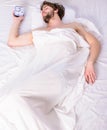 Guy lay under white bedclothes. Fresh bedclothes concept. Man sleepy drowsy unshaven bearded face covered with blanket