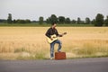 Guy in Leather Jacket Playing Acoustic Guitar on S Royalty Free Stock Photo