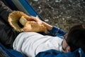 The guy lies in a hammock in the country. man in blue shirt  on vacation Royalty Free Stock Photo