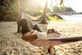 Guy lies in a hammock enjoying solitude and nature, a meditative state and concentration