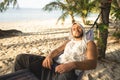 Guy lies in a hammock enjoying solitude and nature, a meditative state and concentration