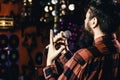 Guy likes to sing in dark karaoke hall. Musician with beard singing song in karaoke, rear view. Rock singer concept. Man Royalty Free Stock Photo