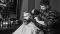 Guy with long dyed blond hair close up. Do not cut your own hair. Hipster client getting haircut. Barber with scissors