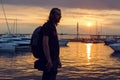 Guy with long hair in silhouette standing on the beach Royalty Free Stock Photo