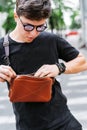 Guy looking for something in his bag. Royalty Free Stock Photo