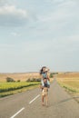 Guy in love circling a girl on the road. Lifestyle, romance, love, travel. Copy space Royalty Free Stock Photo