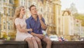 Guy in love making soap bubbles, girlfriend in love sitting next to him, date Royalty Free Stock Photo