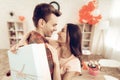 Guy Makes A Gift To Girlfriend On Valentine`s Day. Royalty Free Stock Photo