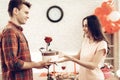 Guy Makes A Gift To Girlfriend On Valentine`s Day. Royalty Free Stock Photo