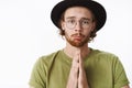 Guy making silly face as asking forgiveness pouting and frowning cute holding hands in pray begging sorry standing timid Royalty Free Stock Photo