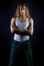 Guy male model with long hair posing in Studio on black background and a white t-shirt and jeans Royalty Free Stock Photo