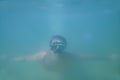 A guy in a mask swims underwater in the sea Royalty Free Stock Photo