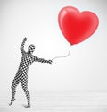 guy in morpsuit body suit looking at a red balloon shaped heart