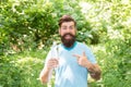 Guy with moustache drink water. mature bearded man pointing finger. summer camping vacation. man hipster hiking. male