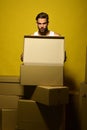 Guy with muscular torso opens box in front. Royalty Free Stock Photo