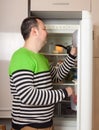 Guy near refrigerator at home Royalty Free Stock Photo
