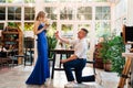 Guy an offer hands and hearts, gives engagement ring to his girlfriend Royalty Free Stock Photo