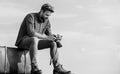 Guy outdoors with vintage suitcase. Photojournalist concept. Travel blog. Man sit on suitcase. Travel blogger. Handsome